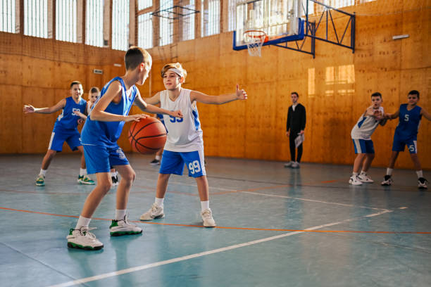 istock Junior basketball team playing basket on training at indoor court. 2154057732