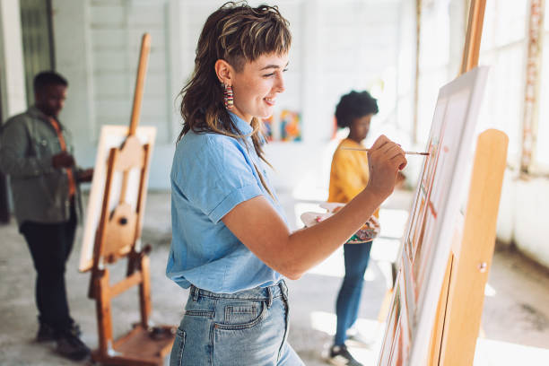 istock Art school creativity: teacher guiding students in canvas painting 2154059513