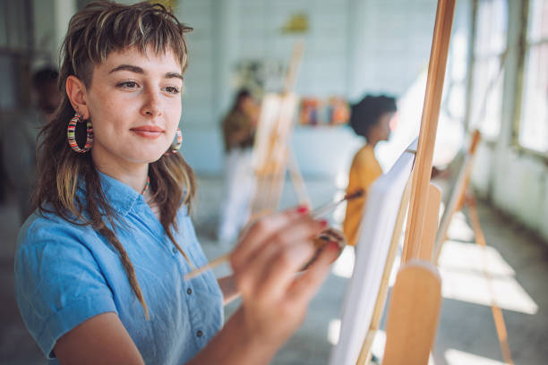 istock Art class in session: teacher and students immerse in painting 2154059576