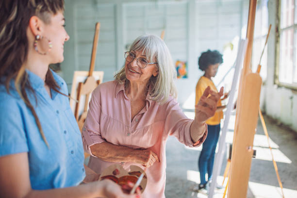 istock Art class in session: teacher guiding student in painting techniques 2154059709