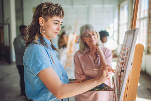 istock Art class in session: teacher guiding students in painting workshop 2154060163