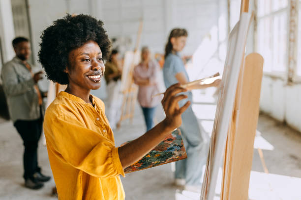 istock Creative learning: art school teacher and students engaged in canvas painting 2154060716