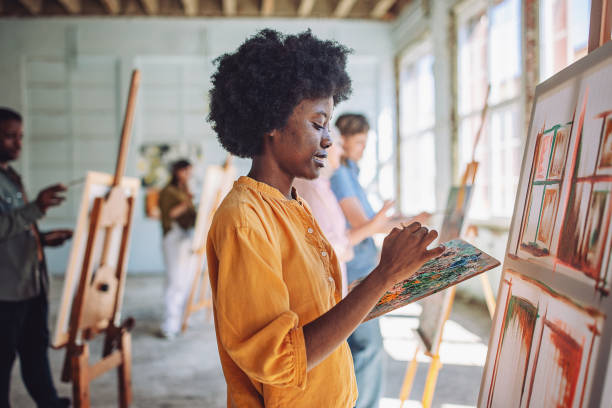 istock Art class in action: teacher and students engage in canvas painting 2154061092