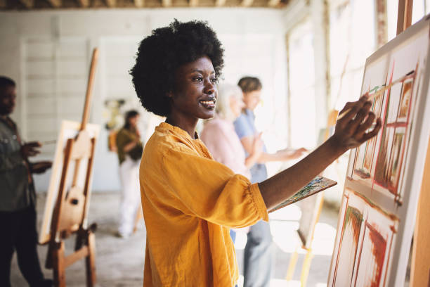 istock Art class in progress: teacher guiding students on canvas painting 2154061299