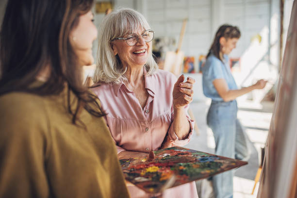 istock Art class in session: teacher guiding students in painting techniques 2154062723