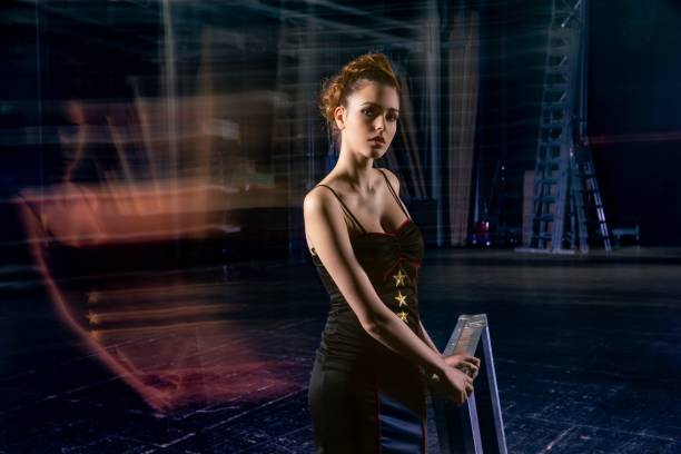 istock Female magician portrait on stage with long exposure light effect 2154063100