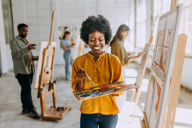 istock Creative workshop: art teacher guiding students in painting class 2154063150