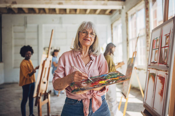 istock Art school creativity - teacher and students engaged in canvas painting 2154064400