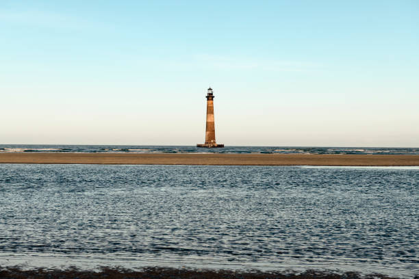 Morris Island Lighthouse from the shoreline of Folly Beach near Charleston, South Carolina.