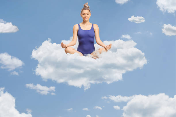 istock Young woman in a swimming suit sitting on a cloud 2154066351