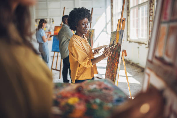 istock Art class in session: teacher guiding students in canvas painting 2154066360