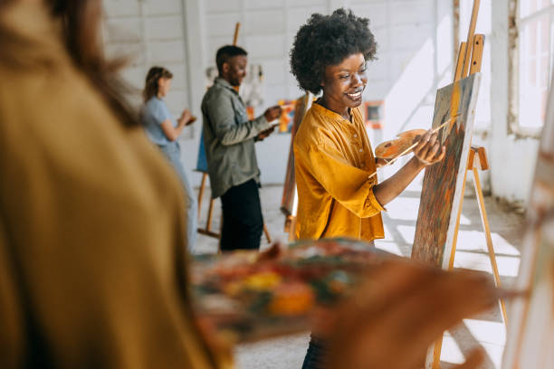 istock Art class in session: teacher and students engaged in painting 2154066611