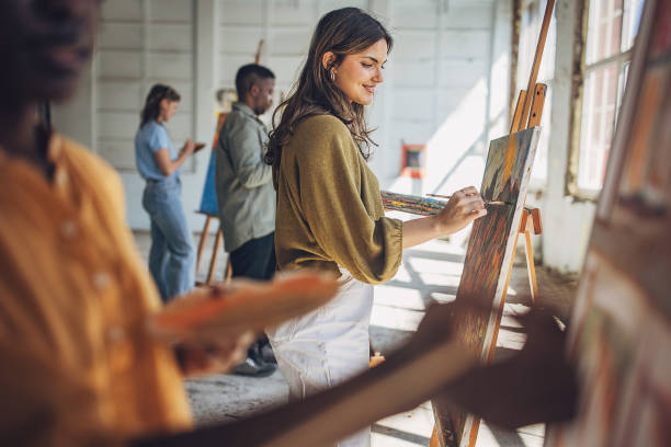 istock Art class in progress: teacher and students engaged in canvas painting 2154066660