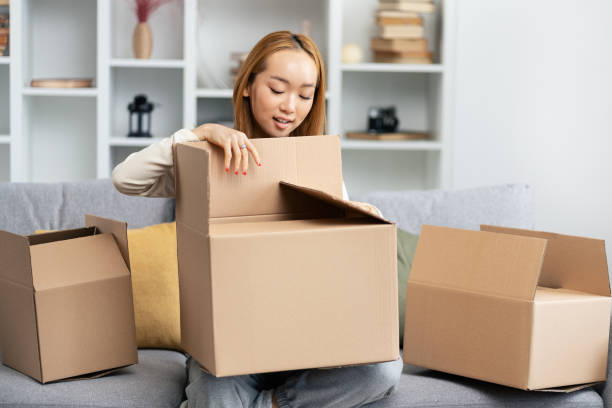 istock Young Woman Unpacking Boxes In New Home, Feeling Happy 2154066685