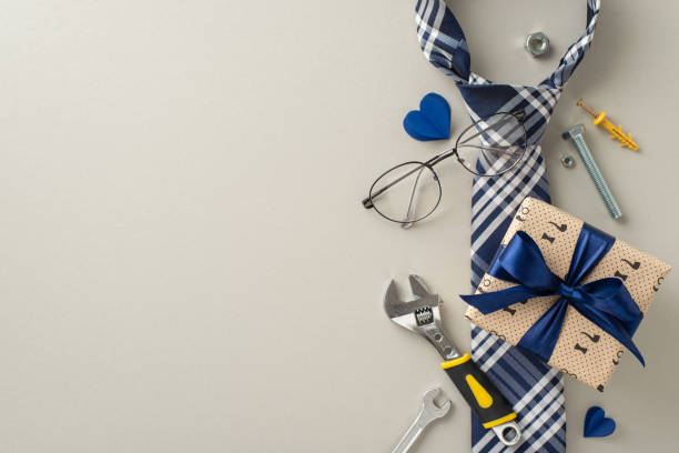 istock Make Father's Day memorable with our deluxe gift collection. Packed with handy tools and elegant accessories, it's a tribute to Dad's hard work. Top view on pastel grey background with space for ads 2154067600