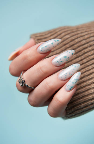 istock Female hands with blue nail design. Blue nail polish manicure. 2154077575