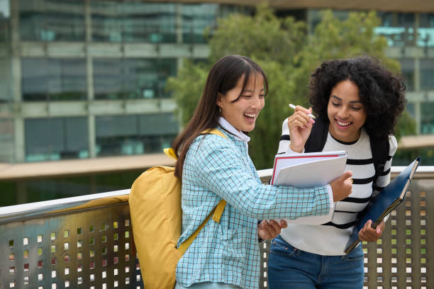 istock Asian and Latin students sharing notes at the University 2154079823