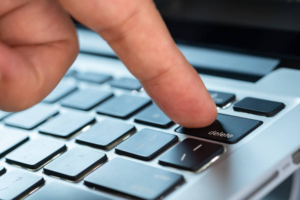 istock Finger of the computer user, he presses the delete button on the computer keyboard. 2154081350