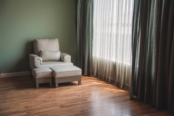 Cozy living room sofa couch home background with copy space. Warm home interior bright simple living space. Home showcase interior light bokeh furniture decor. Home furniture Blurry background