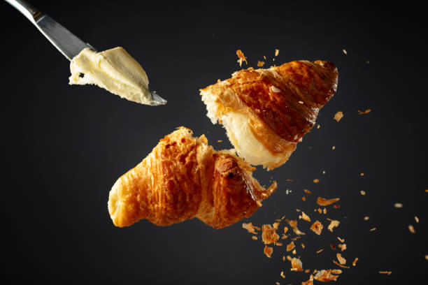 istock Croissant in air on a black background. 2154082993