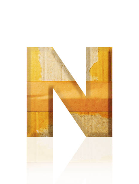Close-up of three-dimensional old cardboard alphabet letter N on white background.