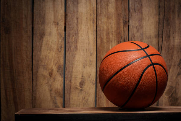 istock Basketball ball lying on a wooden floor 2154084445
