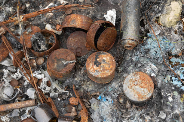 istock Old, rusted metal cans in burned ash. 2154084471