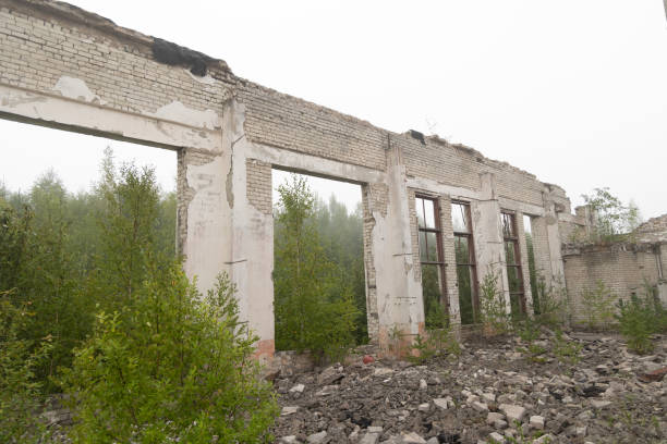 An old, collapsed building in soviet army base in Latvia, Europe. Abandoned white brick building.