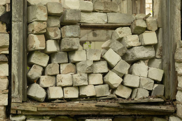 An old, collapsed building in soviet army base in Latvia, Europe. Abandoned white brick building.