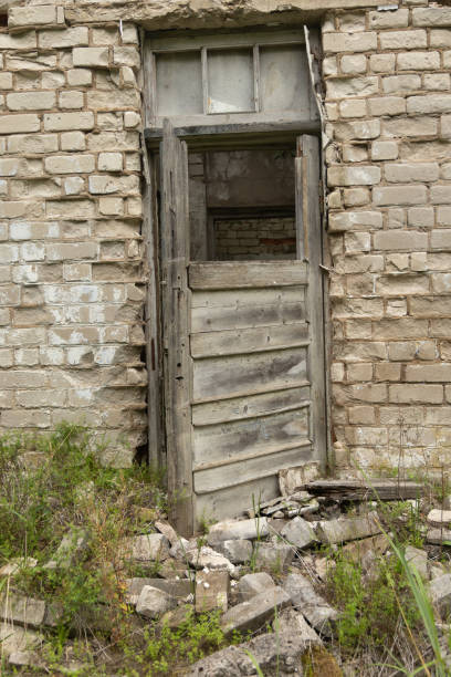 An old, collapsed building in soviet army base in Latvia, Europe. Abandoned white brick building.