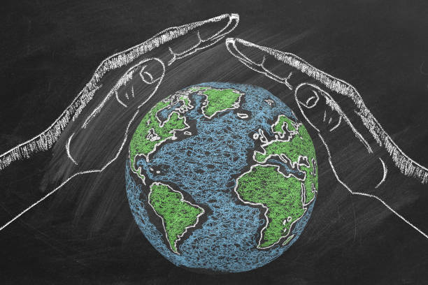 istock Chalk Drawing of Hands Protecting Earth on Blackboard 2154085135