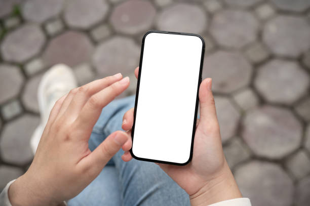 istock A close-up image of a woman using her smartphone while sitting outdoors. 2154087218