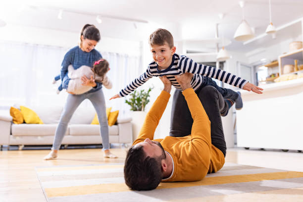 istock Playful parents having fun with their kids at home. 2154087578