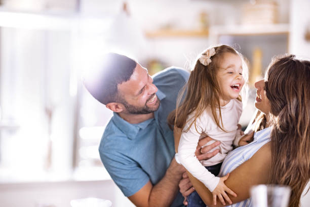 istock Playful parents having fun with their small daughter at home. 2154087635