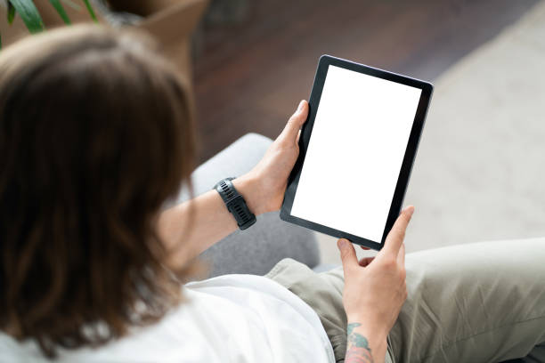 istock Young Woman Using Digital Tablet With Blank Screen At Home 2154087668