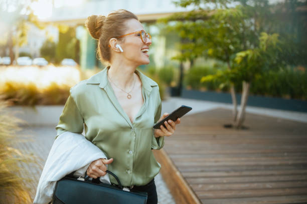 istock business woman using phone and walking 2154088055