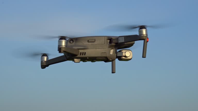 Drone in Flight Hovering Against Blue Sky, Static Closeup