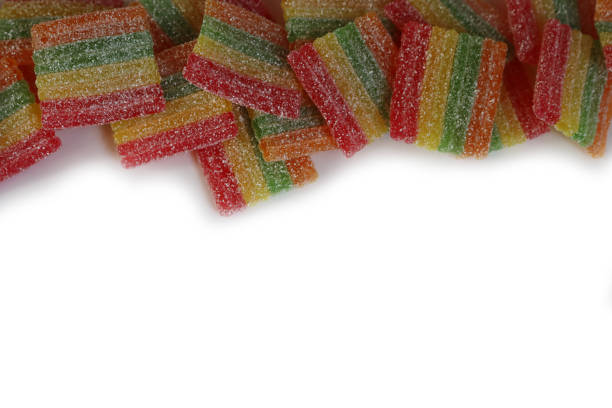 Many Rainbow gummy candies isolated on white background, Sour Jelly Candies Strips in Sugar Sprinkle