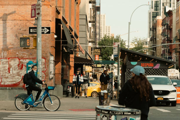 New York, New York, USA - May 5, 2013: Cooper Square in Lower Manhattan. Cooper Square is at the edges of several Manhattan neighborhoods including Greenwich Village, The East Village, and The Bowery. it is also the site of Cooper Union, a well known Manhattan college. People can be seen on the street.