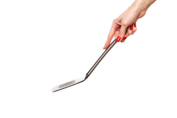 Female hand hold spatula. Isolated on a white background . High quality photo