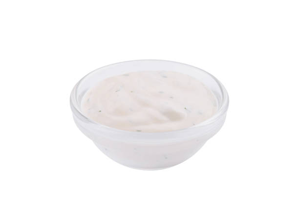 Creamy ranch dressing in clear bowl isolated on white