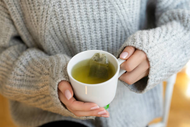 istock Female hands with cup of hot tea 2154095453