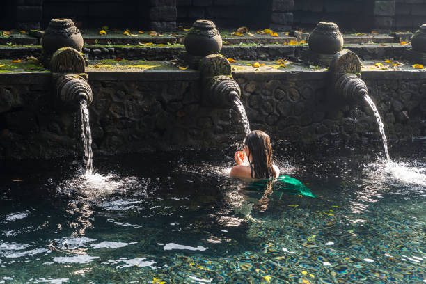 istock Woman doing purifying ritual in Tirta empul holy spring, Ubud 2154095579