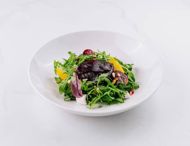 istock Fresh mixed green salad on a white plate 2154095638