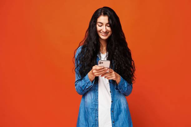 istock Young woman on orange background 2154096447