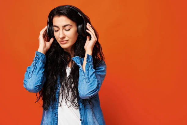 istock Young woman on orange background 2154096526