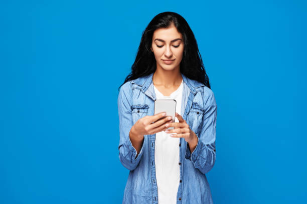 istock Young woman on blue background 2154096540
