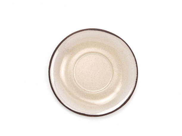Top view, empty beige round ceramic plate with brown rim isolated on a white background.