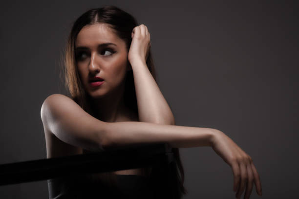 Beautiful girl studio portrait against dark background.