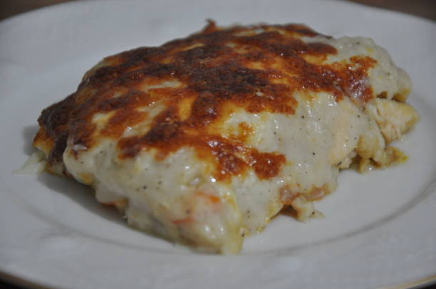 istock Chicken baked with bechamel sauce on plate 2154100076
